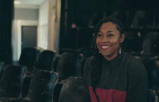 Poet Keisha Thompson in an auditorium