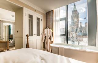 Hotel bedroom with bathtub and view to Manchester Town Hall