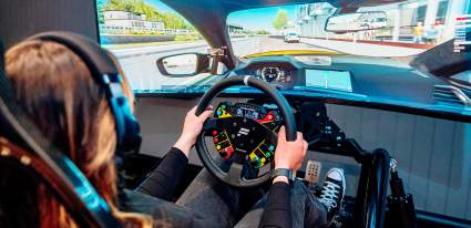 A picture showing a person in a race simulator