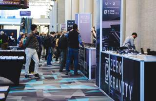 Conference attendees of Zero Gravity Summit walking around in the Salt Palace Convention Center.