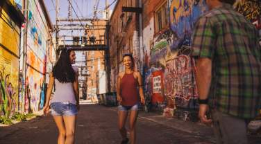 people walking through art alley in downtown rapid city, sd