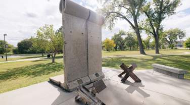 pieces of the berlin wall and tank traps that are found in memorial park in rapid city south dakota