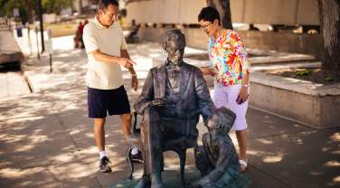 couple exploring the abraham lincoln statue, part of the city of presidents tour in rapid city, sd