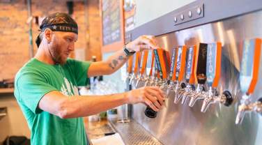 Bartender pouring a beer from the Dakota Point Brewing taps in Rapid City, South Dakota