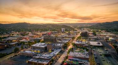 drone sunset view over rapid city with the black hills in view