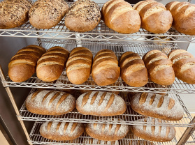 several racks of fresh baked artisan bread