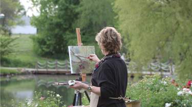 Woman painting in plein air at the Monet Garden at the Overland Park Arboretum and Botanical Gardens