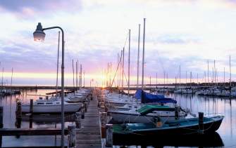 Boats docked on Long Beach Harbor Gulf Coast at sunset