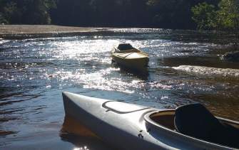 Empty Kayaks in River
