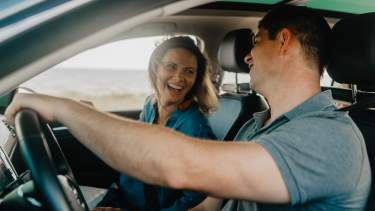 A Man and Woman Driving Along Beach Boulevard