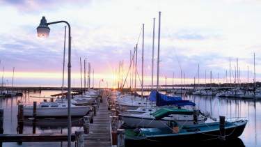 Boats docked on Long Beach Harbor Gulf Coast at sunset