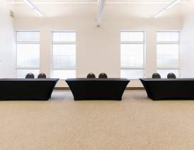 3 tables with black tablecloths