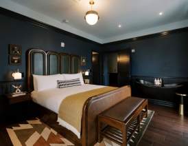Hotel room with bed, rug, nightstand