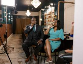 Two people drinking a glass of bourbon in a tasting room
