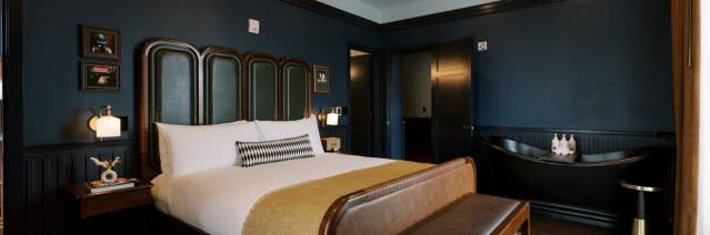 Hotel room with bed, rug, nightstand