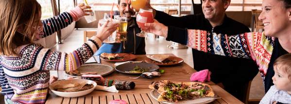 Family cheers-ing while dining and drinking at Meier's Creek Brewing Company in Cazenovia, NY