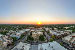 Yellow sun setting over the skyline in Downtown McKinney