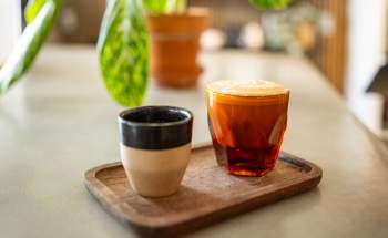 Two hot coffee lates on a wooden tray from Filtered Coffee Shop