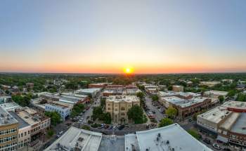 Yellow sun setting over the skyline in Downtown McKinney
