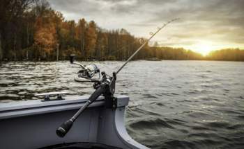 Lake with boat and fishing rod