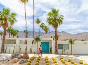 man walking in front of midcentury house in palm springs