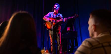A man playing guitar on stage