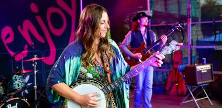 Musicians on stage playing banjo and guitar