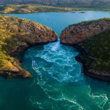 An aerial view of the tide flowing through the narrow gap at the Horizontal Falls on the Kimberley Coast