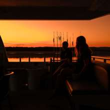 Unwind on deck as the Kimberley sky lights up at sunset.