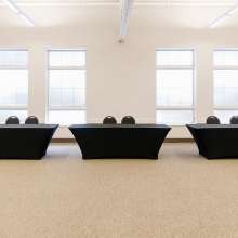 3 tables with black tablecloths