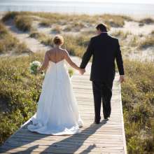 married couple walking on board walk