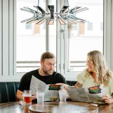 couple eating burgers in a chic restaurant