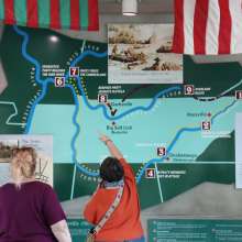 two ladies studying a wall map of the Cumberland River and its tributaries