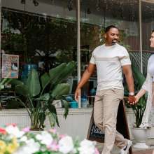 couple walking outside of a pottery gallery