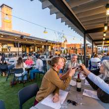 People eating outside at The Mailroom