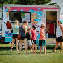 Locals getting ice cream from an ice cream truck.
