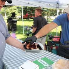 A man serving ribs.