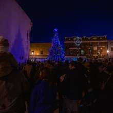people gathered on the street in front of the christmas tree on walker square for light up downtown