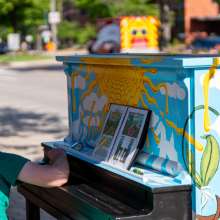 Man painting piano