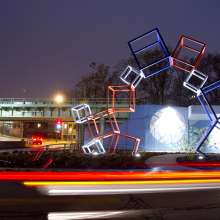 Metaform sculpture and mural at night