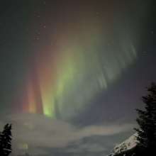 Rainbow colored northern lights ove Piedad road. Haines, Alaska