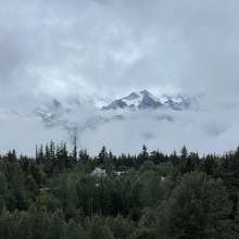 The mountain peaking through the clouds looking from the Carnival Luminosa