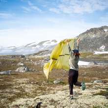 summit view women drying out rain fly by blowing in the fresh air