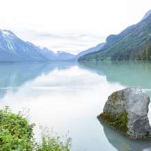 Breathtaking view of Chilkoot Lake with one man fishing.  I