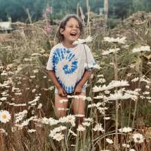 young girl in field of daises