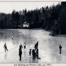 Ice skating on Mirror Lake under the lights. Mirror Lake and Lake Sequoyah supplied both ice for food storage and recreation before general warming led to milder winters.  Photo ca. 1955.
