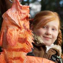 Girl holding a rock fish