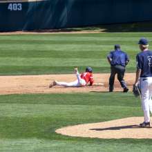 Baseball player sliding to base