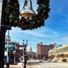 Holiday wreath with bell and downtown lansing