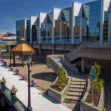 People walking on the Lansing River Trail by the outdoor space at the Lansing Center